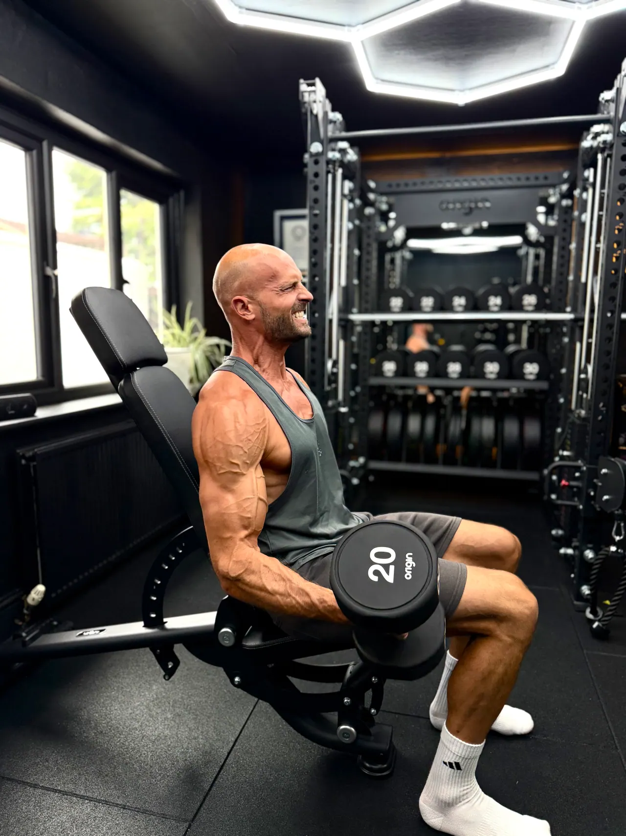 Daniel lifting weights in his gym