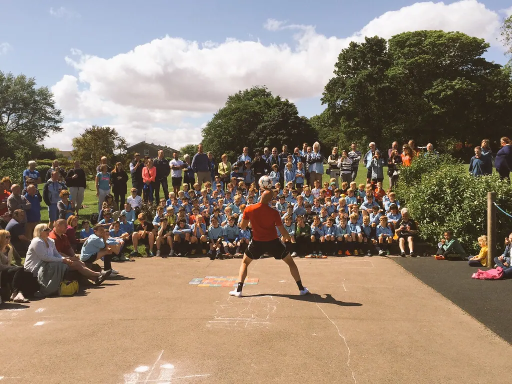 Daniel performing at a school